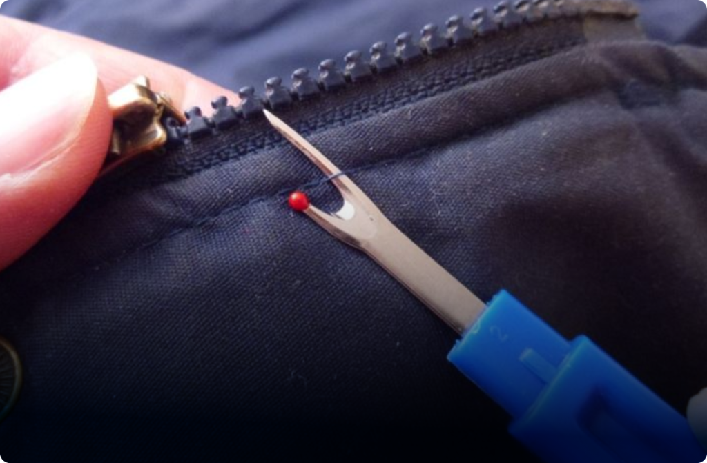 Photo of our tailor repairing a zipper