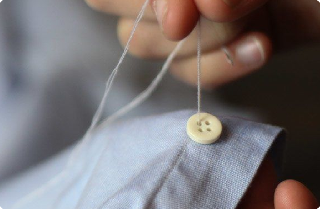 Photo of Our Seamstress Sewing on a Button